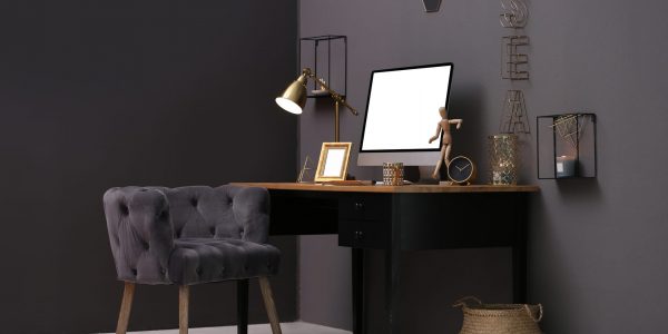 Modern computer on table in stylish office interior